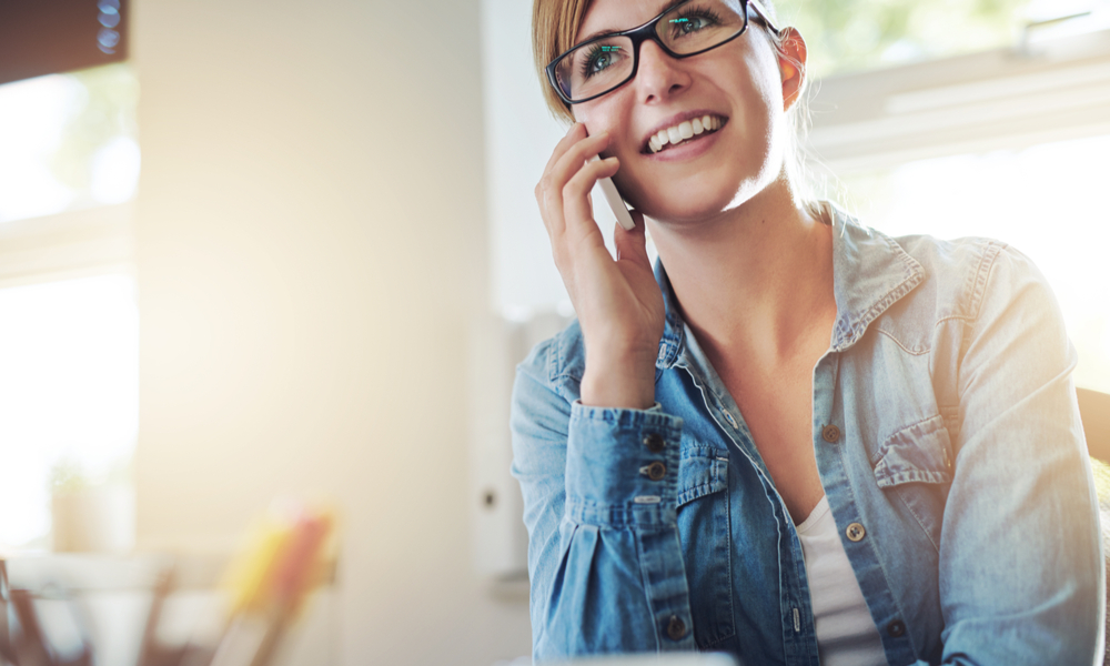   How to find cheap last minute flights: woman on the phone with airline trying to book last minute flight