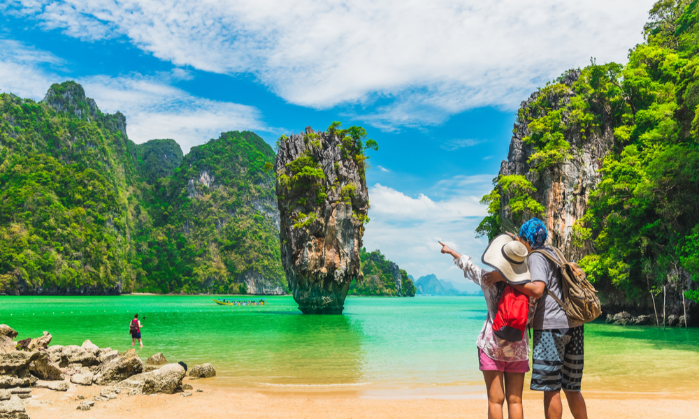 6 Under-the-Radar Romantic Getaways: Happy couple on the beach in phuket, thailand