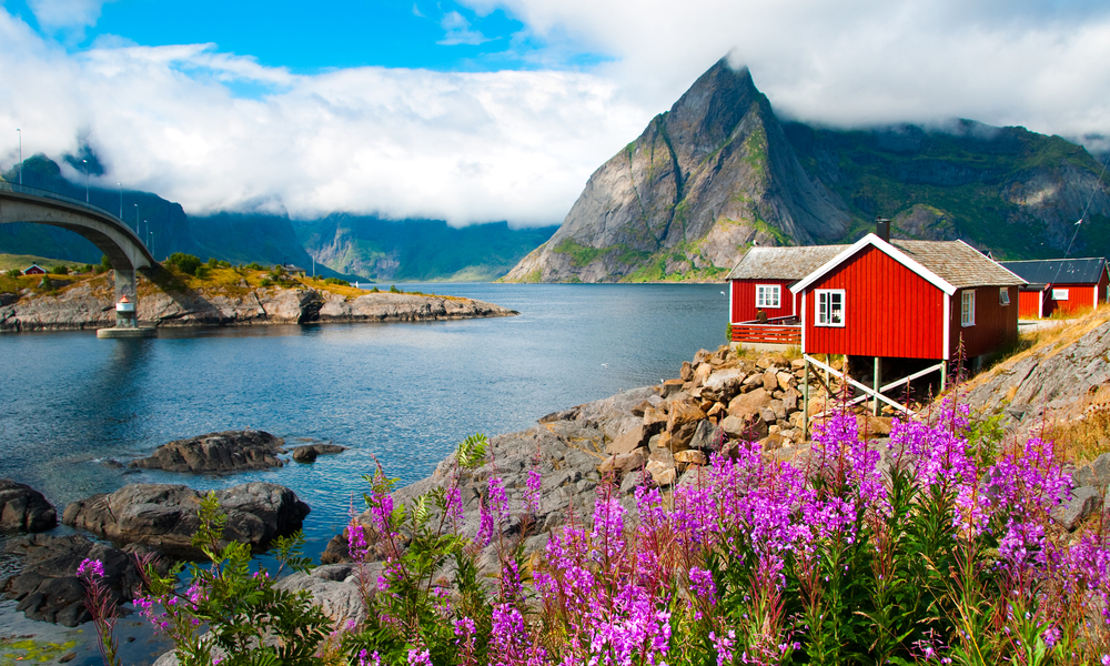 6 Under-the-Radar Romantic Getaways: Typical red fishing houses in a Harbor on Lofoten islands, Norway