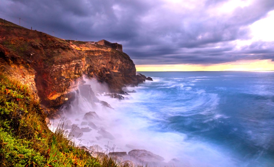 Seascape view of the big waves in the Nazare canyon. Big waves splashing against the rocks at Praia do Norte, Nazare - Portugal