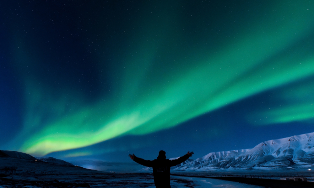 The polar Northern lights in Norway's Svalbard, casting a silhouette on the mountains