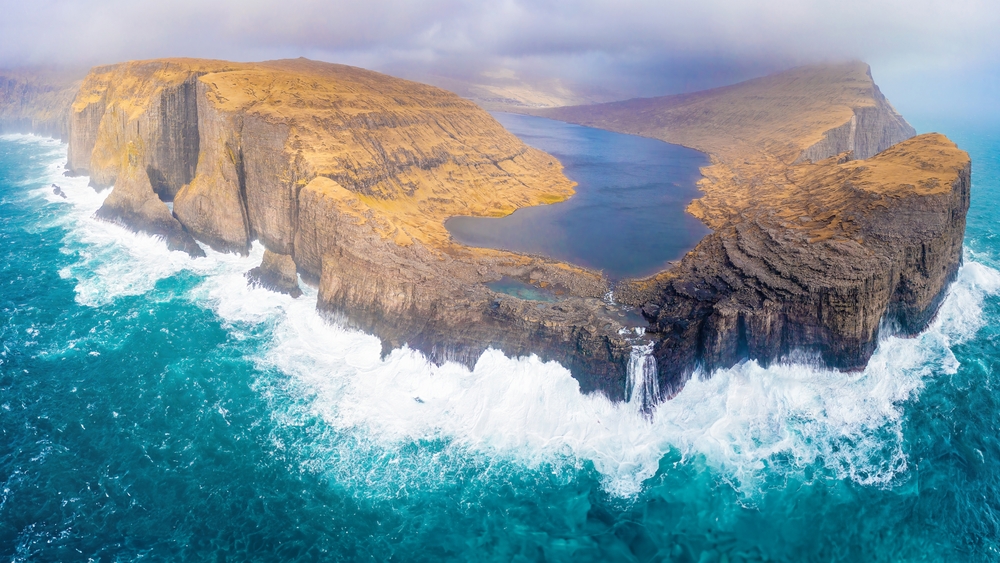 A helicopter view of "Sørvágsvatn" which is the largest lake in the Faroe Islands. It is situated on the island of Vágar between the municipalities of Sørvágur and Vágar.