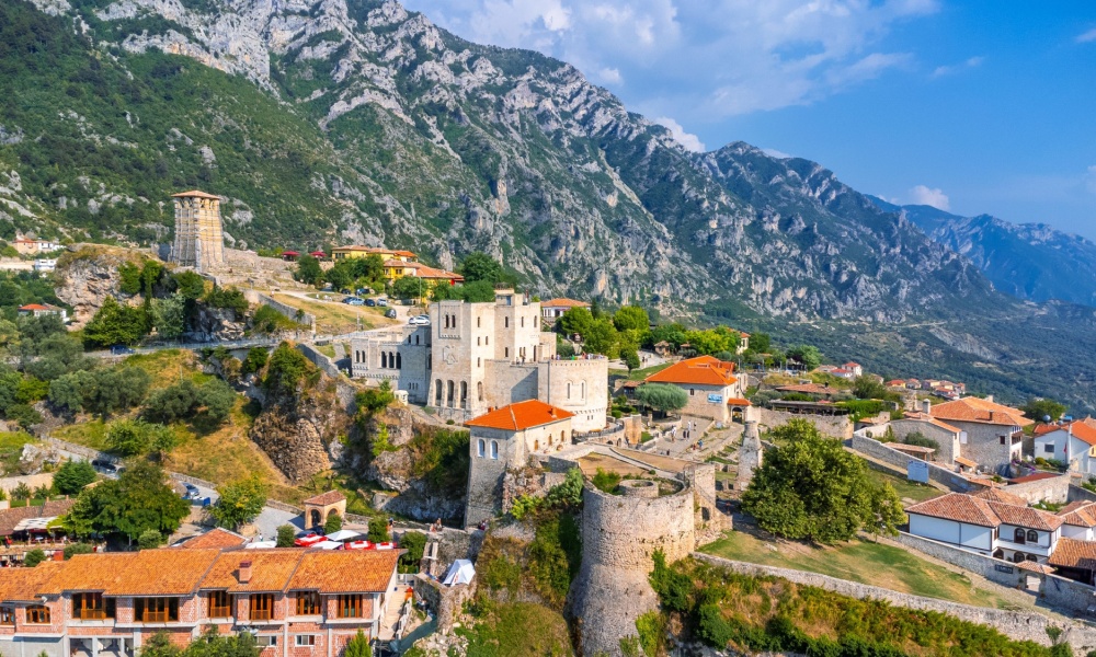 Aerial drone view of Kruje Castle and its fortress, inside the Kruje tower and museum with the mountains in the background. Albania